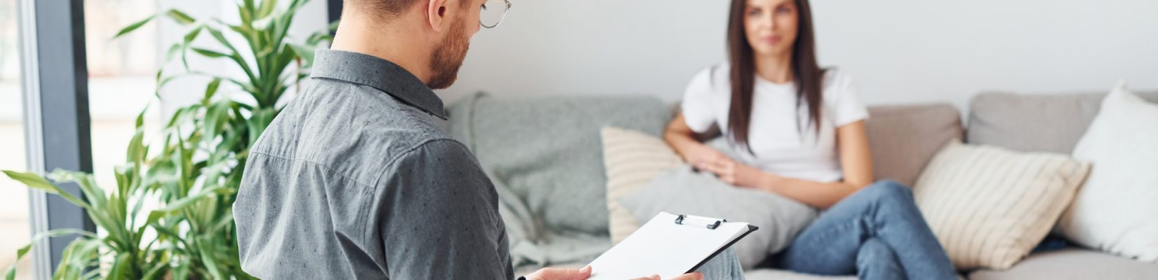 Young woman at a reception at a psychologist. Sits on the sofa